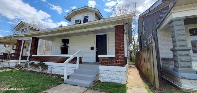 502 Montana Ave, Louisville, KY 40208 - view of front facade featuring brick siding and a porch