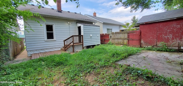 502 Montana Ave, Louisville, KY 40208 - back of house with a chimney, fence, and a patio area