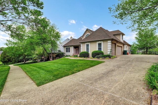 view of front of home featuring stucco siding, a front yard, driveway, an attached garage, and a shingled roof