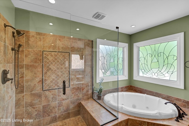 full bath with a stall shower, a tub with jets, and recessed lighting