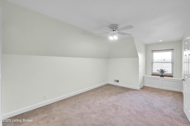 additional living space featuring carpet floors, a ceiling fan, baseboards, and lofted ceiling