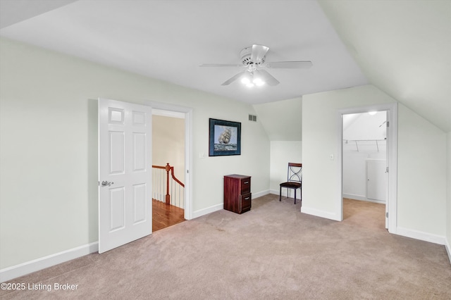 additional living space featuring carpet, a ceiling fan, lofted ceiling, and baseboards
