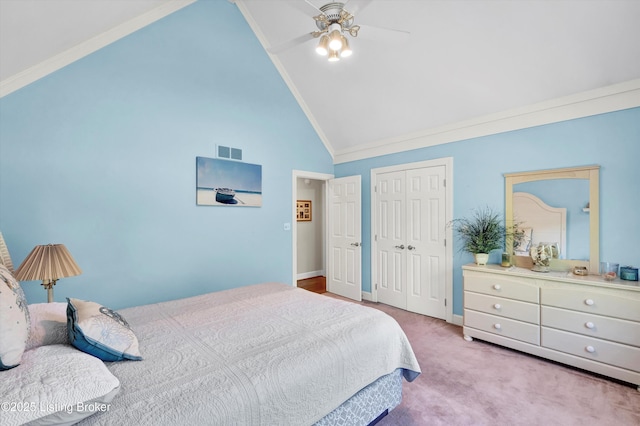 bedroom with a closet, high vaulted ceiling, carpet, baseboards, and a ceiling fan