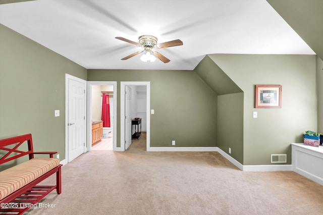 unfurnished room with ceiling fan, light colored carpet, and baseboards