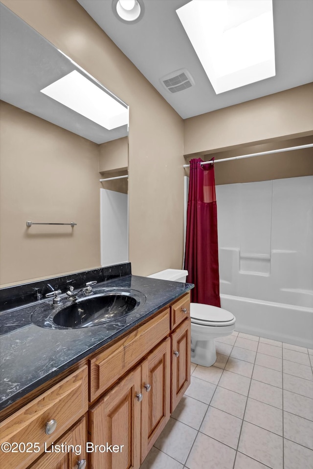 full bathroom featuring tile patterned flooring, a skylight, toilet, vanity, and shower / bathtub combination with curtain