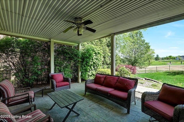 view of patio / terrace with an outdoor hangout area, fence, and a ceiling fan