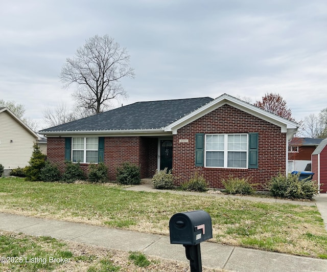 single story home with a front lawn, brick siding, and roof with shingles