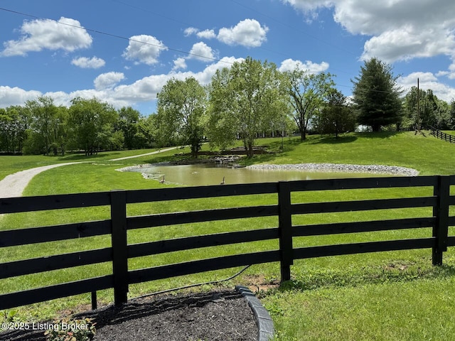 gate featuring a water view and view of scattered trees