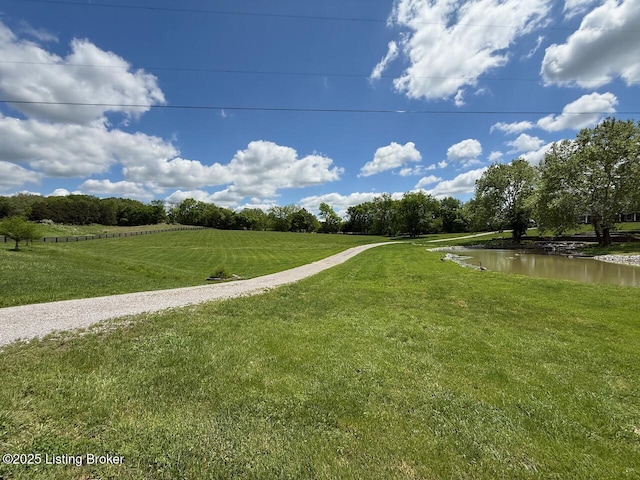 view of property's community featuring a yard and a rural view