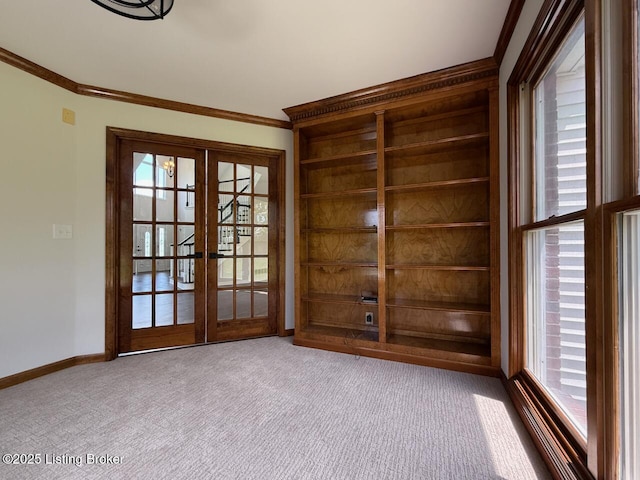doorway to outside with ornamental molding, carpet floors, french doors, and baseboards