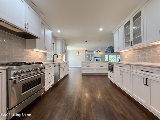 kitchen featuring stainless steel appliances, baseboards, dark wood-type flooring, glass insert cabinets, and white cabinetry