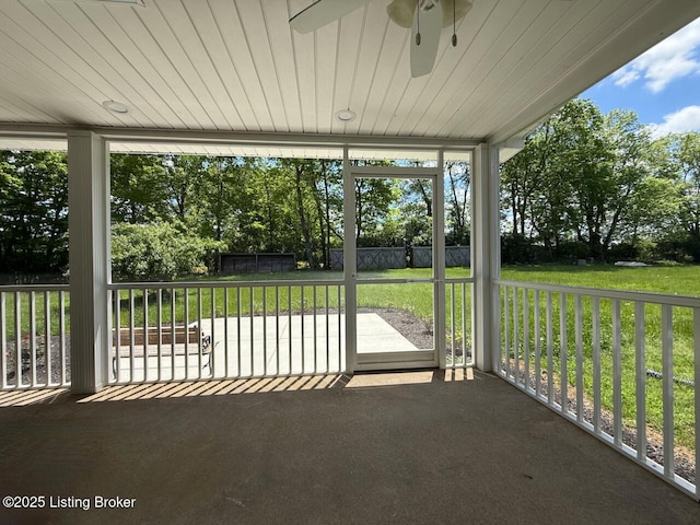unfurnished sunroom with a ceiling fan