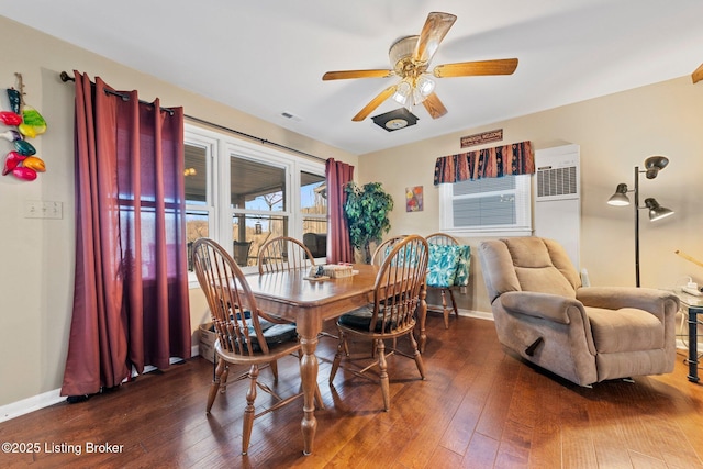 dining space featuring baseboards, visible vents, a ceiling fan, and dark wood-style flooring