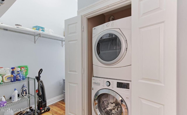 1217 S 4th St, Louisville, KY 40203 - washroom with baseboards, light wood-style floors, stacked washer and dryer, and laundry area