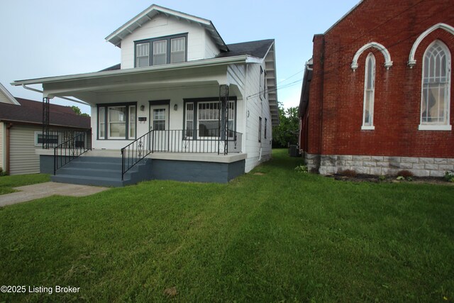 4832 N Main, Eminence, KY 40019 - view of front of property featuring a front lawn, covered porch, central AC unit, and brick siding