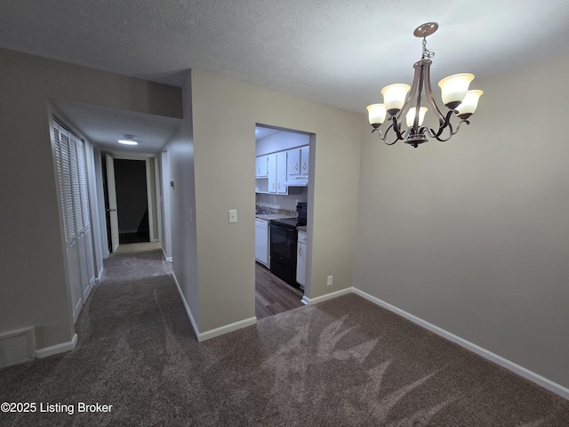 unfurnished dining area featuring a textured ceiling, visible vents, a chandelier, baseboards, and dark colored carpet