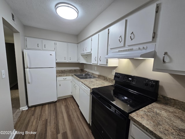 kitchen with a sink, under cabinet range hood, white appliances, white cabinets, and dark wood-type flooring