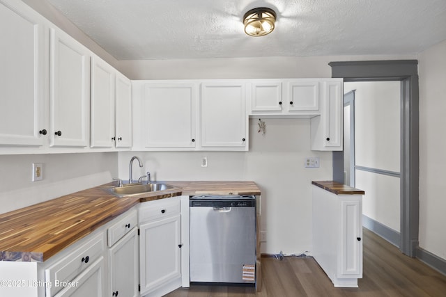 kitchen featuring wooden counters, white cabinetry, a sink, and stainless steel dishwasher