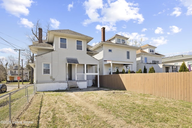 back of house with a yard, a chimney, and fence private yard