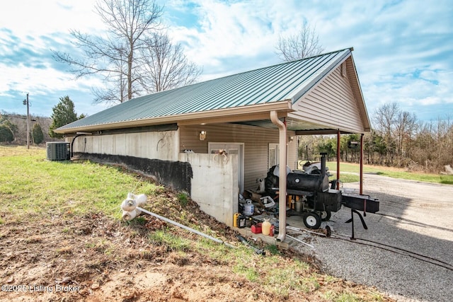 1400 Bewleyville Rosetta Rd, Irvington, KY 40146 - view of property exterior with metal roof, central AC, a standing seam roof, a lawn, and a carport