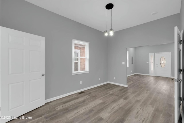 2203 Date St, Louisville, KY 40210 - spare room featuring baseboards, visible vents, and wood finished floors