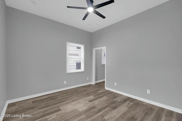2203 Date St, Louisville, KY 40210 - empty room featuring baseboards, wood finished floors, and a ceiling fan