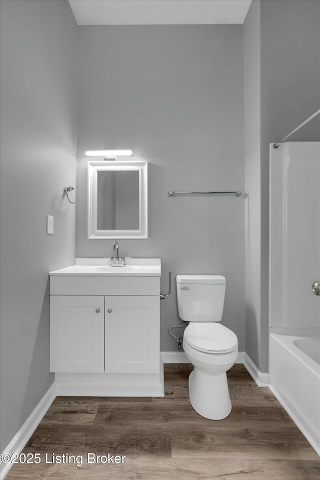 2203 Date St, Louisville, KY 40210 - bathroom with toilet, vanity,  shower combination, wood finished floors, and baseboards