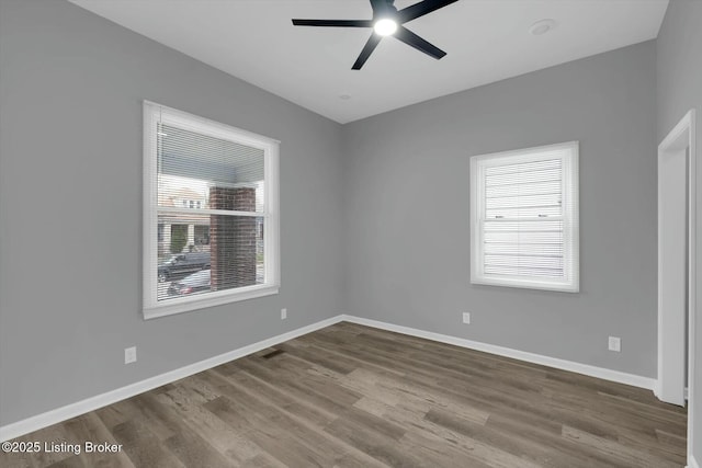 2203 Date St, Louisville, KY 40210 - empty room with dark wood-style flooring, visible vents, baseboards, and ceiling fan
