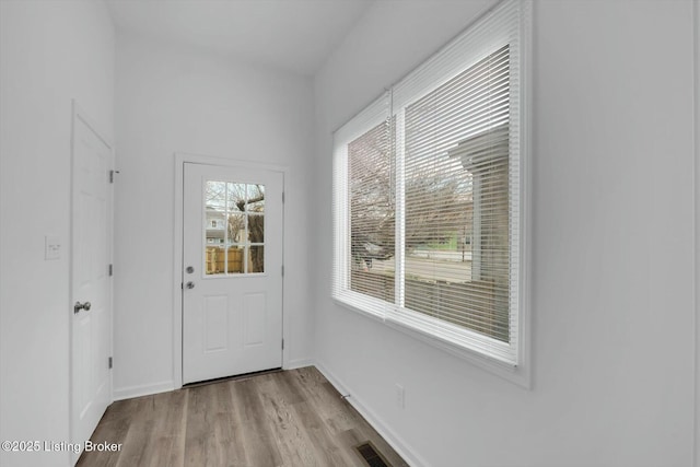 2203 Date St, Louisville, KY 40210 - entryway featuring baseboards, visible vents, and light wood-style floors