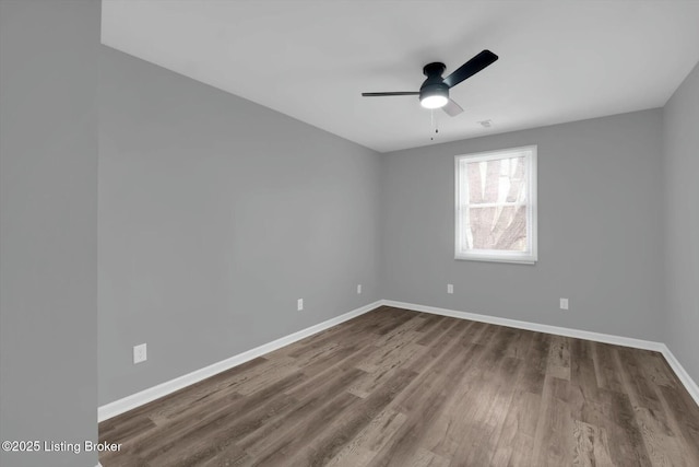 2203 Date St, Louisville, KY 40210 - spare room featuring a ceiling fan, dark wood-style floors, and baseboards