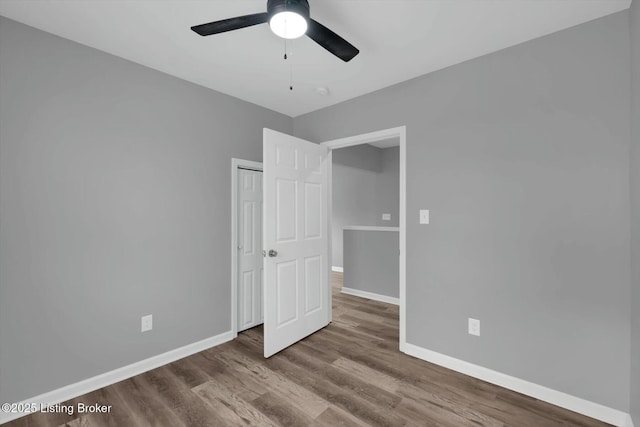 2203 Date St, Louisville, KY 40210 - unfurnished bedroom with baseboards, wood finished floors, a closet, and a ceiling fan