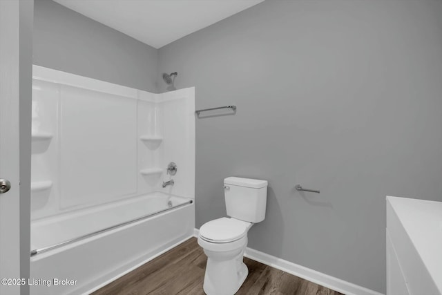 2203 Date St, Louisville, KY 40210 - full bath with baseboards, bathtub / shower combination, toilet, and wood finished floors