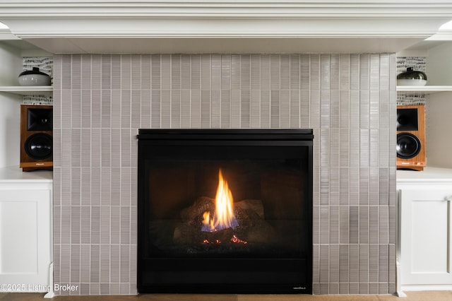 interior details featuring a lit fireplace