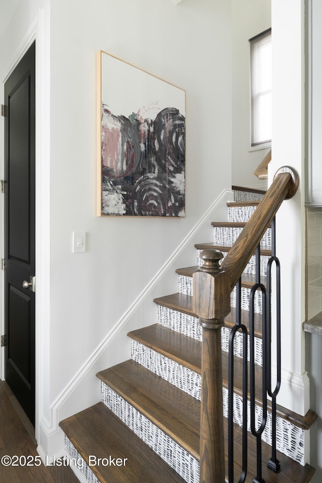 stairs featuring baseboards and wood finished floors