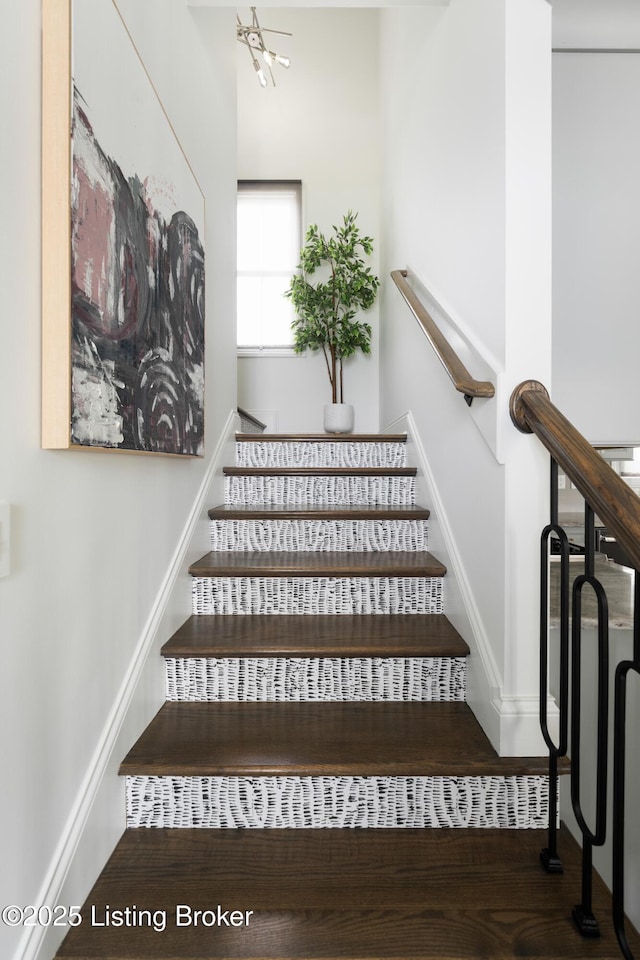 staircase featuring baseboards