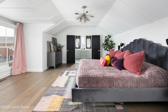 bedroom with baseboards, multiple windows, vaulted ceiling, and wood finished floors