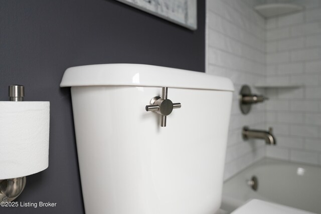 bathroom with shower / bath combination and toilet