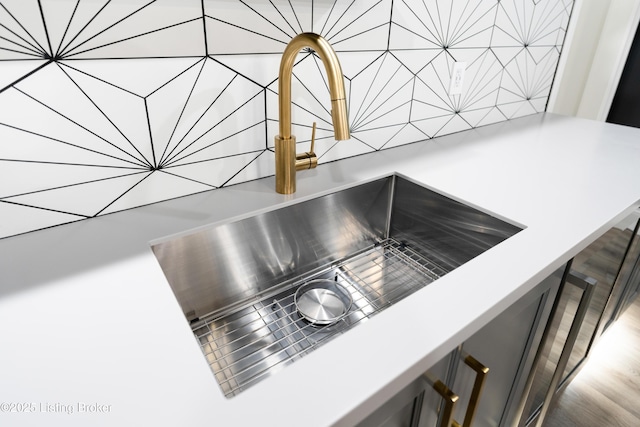 details with a sink, light countertops, and decorative backsplash