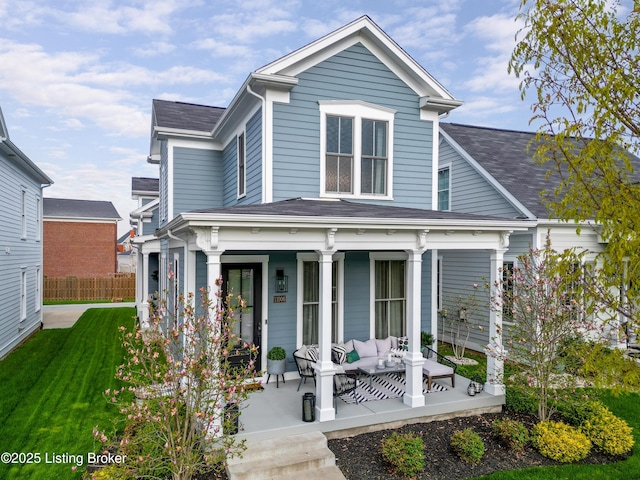 view of front of home featuring an outdoor living space, a front lawn, fence, a shingled roof, and covered porch