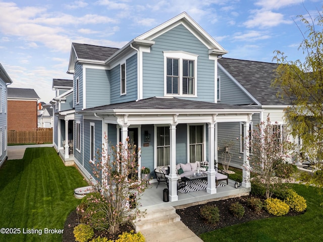 rear view of house featuring roof with shingles, an outdoor living space, a yard, fence, and covered porch