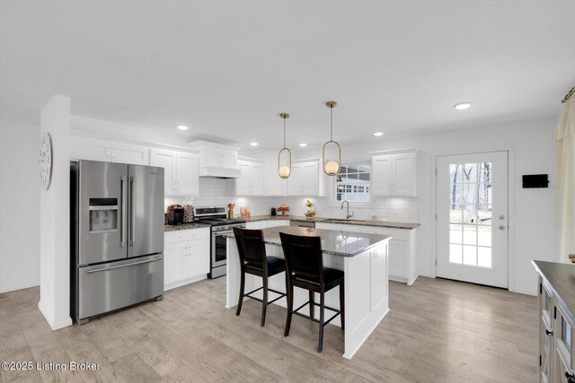 100 Bellemeade St, Brandenburg, KY 40108 - kitchen featuring white cabinets, light wood finished floors, backsplash, and appliances with stainless steel finishes