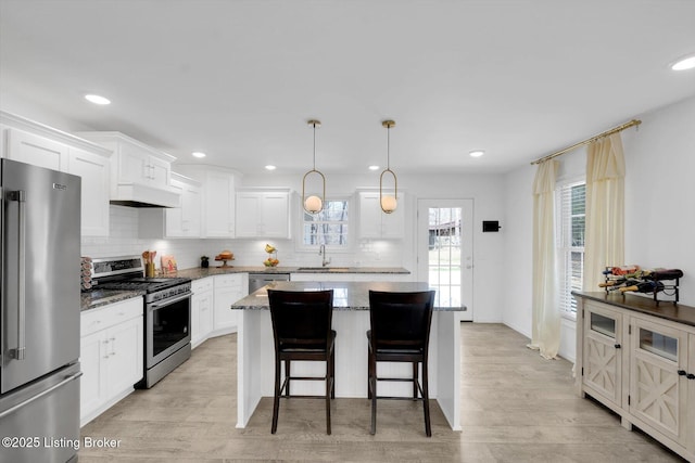 100 Bellemeade St, Brandenburg, KY 40108 - kitchen with tasteful backsplash, a center island, white cabinetry, dark stone counters, and stainless steel appliances