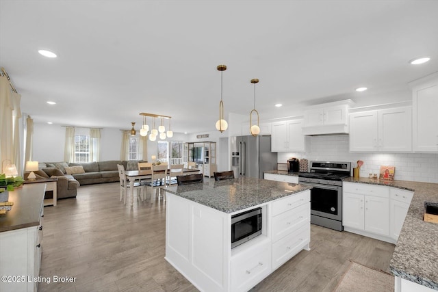 100 Bellemeade St, Brandenburg, KY 40108 - kitchen with premium range hood, light wood-style floors, recessed lighting, stainless steel appliances, and backsplash
