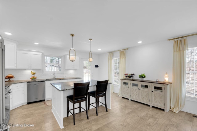 100 Bellemeade St, Brandenburg, KY 40108 - kitchen with light wood finished floors, a sink, backsplash, and stainless steel appliances