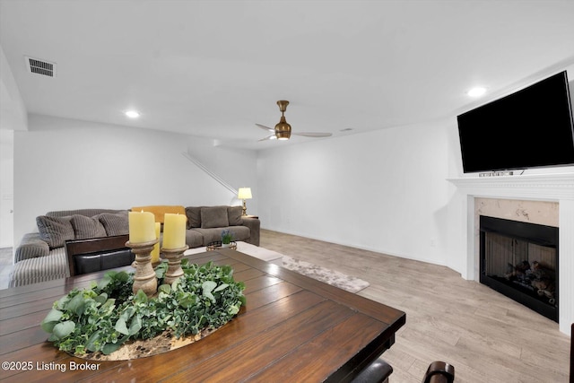 100 Bellemeade St, Brandenburg, KY 40108 - living room with ceiling fan, visible vents, recessed lighting, wood finished floors, and a premium fireplace