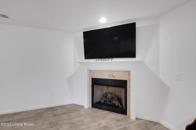 100 Bellemeade St, Brandenburg, KY 40108 - room details featuring baseboards, wood finished floors, a high end fireplace, and visible vents