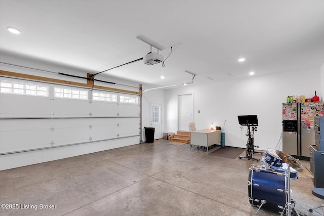 100 Bellemeade St, Brandenburg, KY 40108 - garage featuring recessed lighting, stainless steel refrigerator with ice dispenser, and a garage door opener