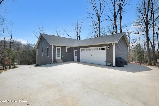 100 Bellemeade St, Brandenburg, KY 40108 - view of front of property with central AC unit, a shingled roof, entry steps, a garage, and driveway