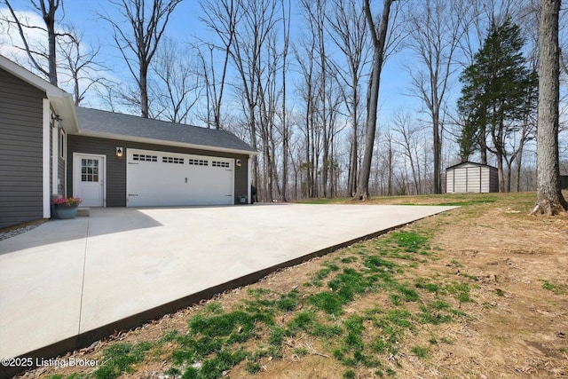 100 Bellemeade St, Brandenburg, KY 40108 - view of yard featuring a storage shed, a garage, and concrete driveway
