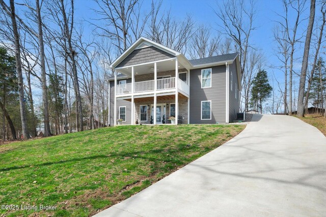100 Bellemeade St, Brandenburg, KY 40108 - view of front of home featuring concrete driveway, a front yard, and a balcony
